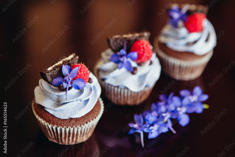 Beautiful and tasty muffins with raspberries and flowers