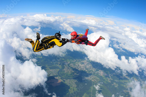 Two skydivers are in the sky.