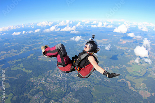 Girl skydiver is in the sky