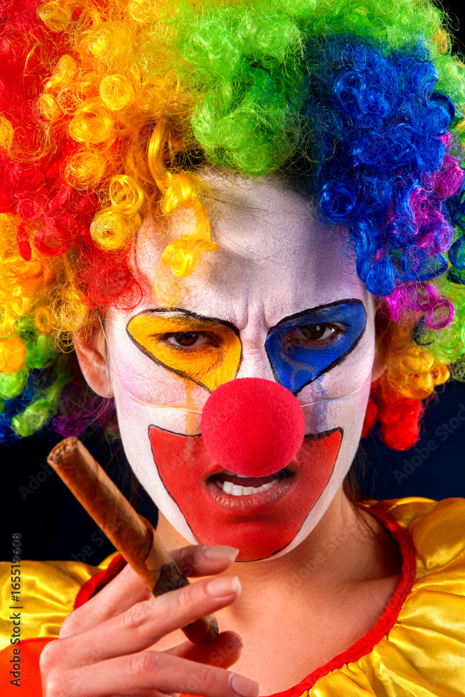 Evil clown on black background. Mad woman is smoking cigar. Portrait of ...