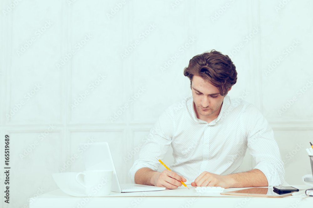 Businessman using laptop with tablet and pen Businessman using laptop with tablet and pen