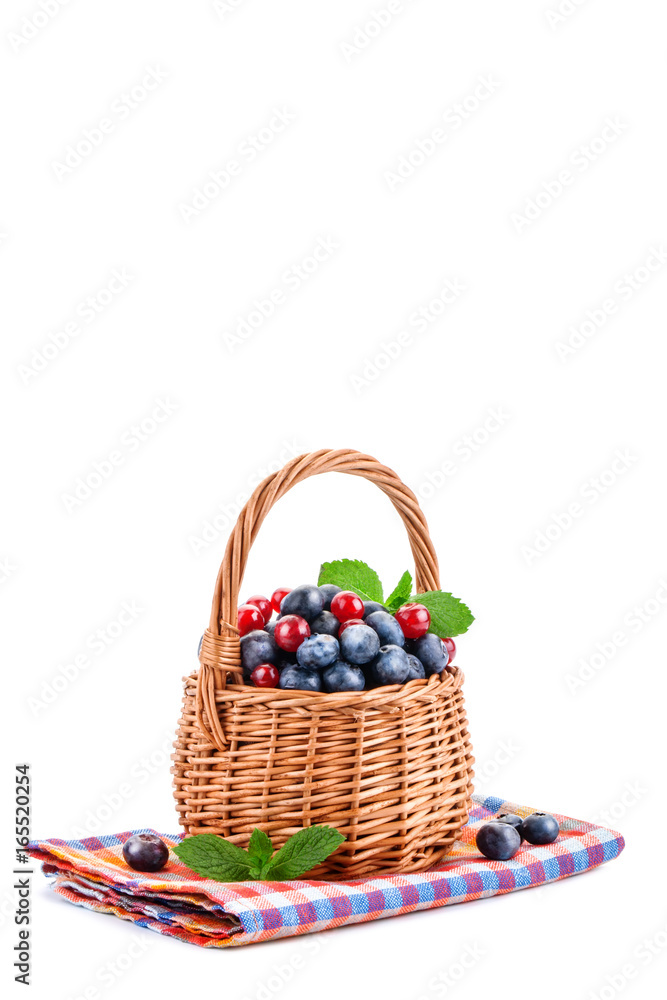 Basket with blueberries and red currants isolated on white background. Basket with blueberries and red currants isolated on white background.