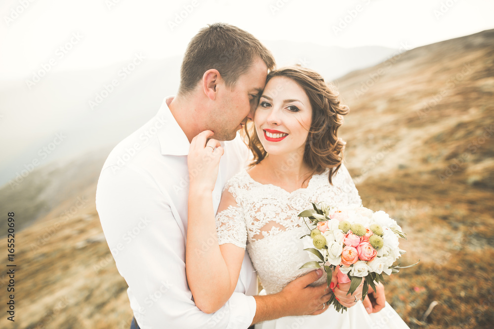 Beautiful gorgeous bride posing to groom and having fun, luxury ceremony at mountains with amazing view, space for text, wedding couple Beautiful gorgeous bride posing to groom and having fun, luxury ceremony at mountains with amazing view, space for text, wedding couple