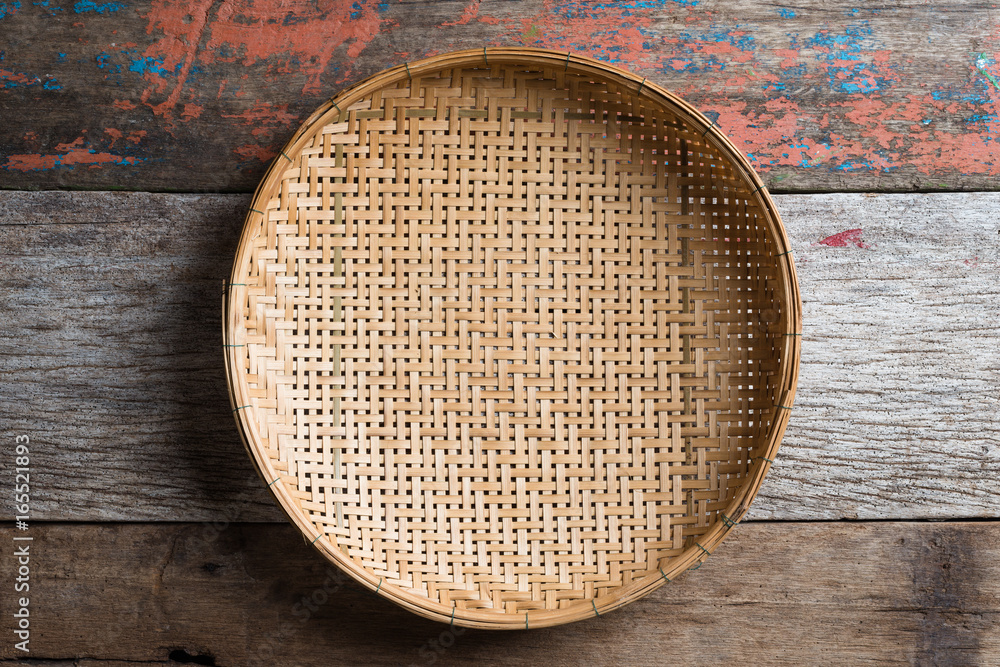 threshing basket on rustic wood background threshing basket on rustic wood background