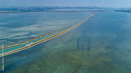 Aerial view of boats in canal in lagoon of Mediterranean sea Etang de Thau water from above, travel by barge in South France
 photo