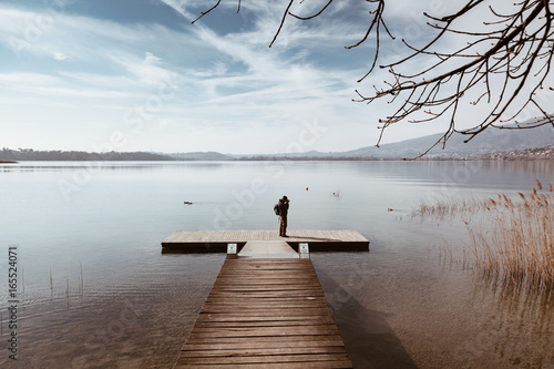 Man taking photo and relaxing at the lake of Annone in italy photo
