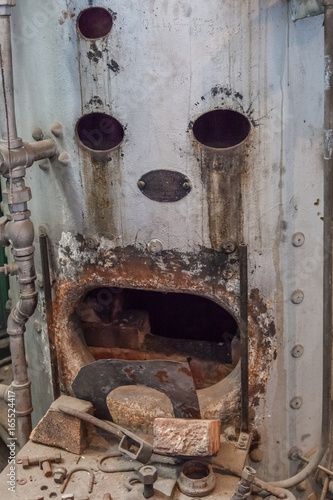 boiler in abandoned steam plant factory that looks like a sad face photo