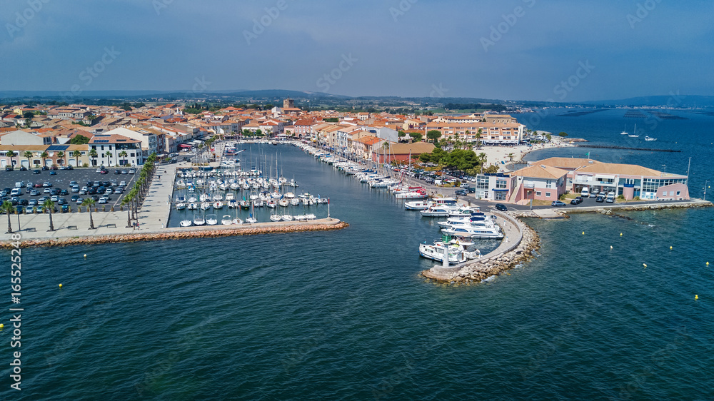 Aerial top view of boats and yachts in marina from above, harbor of Meze town, South France
