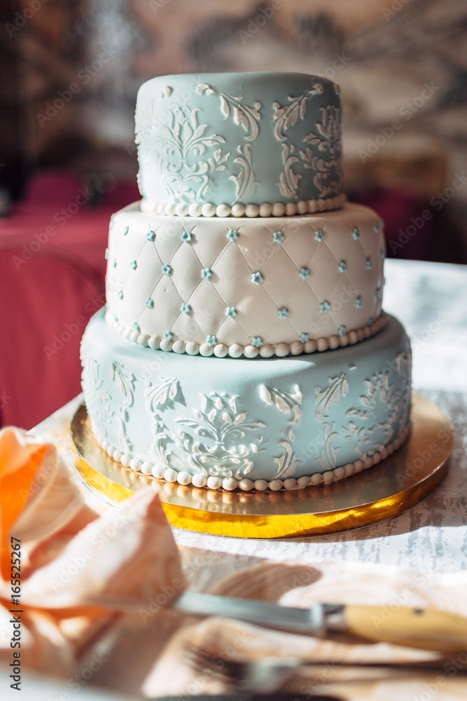 The beautiful cake stands on the wedding table The beautiful cake stands on the wedding table