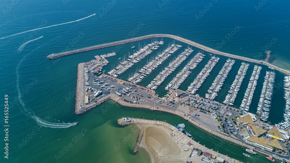 Aerial top view of boats and yachts in modern marina from above, Mediterranean sea, South France
