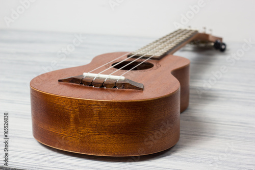 Close up of ukulele on old wooden background photo