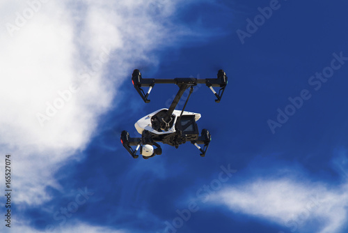 Flying drone on blue sky