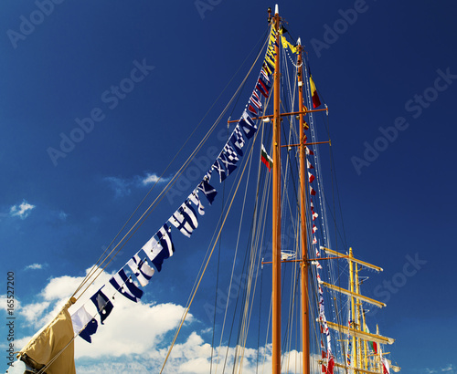Masts of sailing ship on blue sky