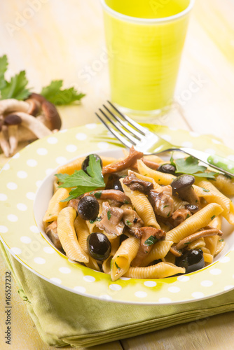 pasta with mushroom and black olives  selective focus