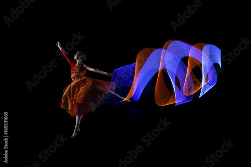 Fototapeta Naklejka Na Ścianę i Meble -  Beautiful ballerina dancer with colorful lights effect