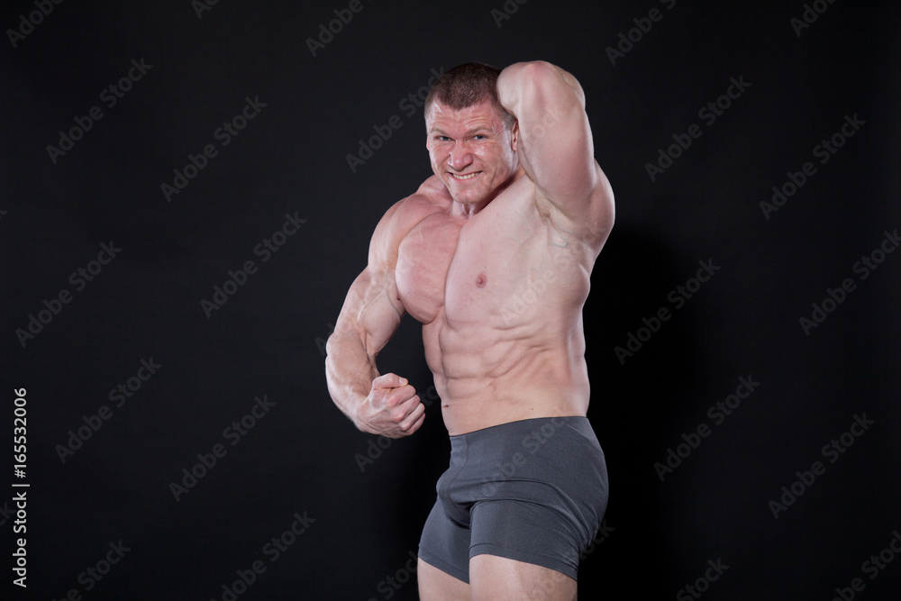 Sport the athlete bodybuilder shows off his muscles Sport the athlete bodybuilder shows off his muscles