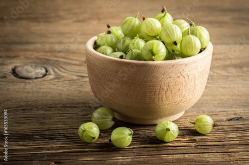 Fresh gooseberry in a wooden bowl. photo