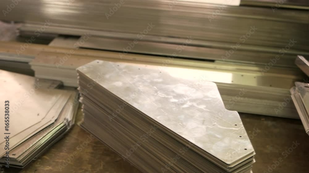 Stack of thin steel parts. Metal sheets on the table. Light aluminium alloys. Stack of thin steel parts. Metal sheets on the table. Light aluminium alloys.