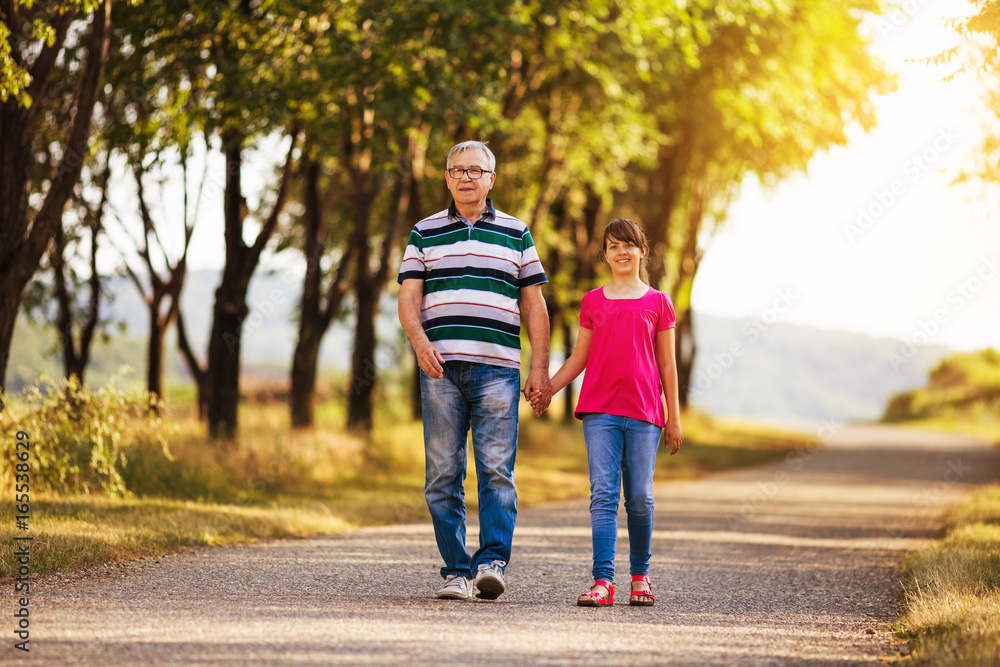 Happy grandfather and granddaughter spending time together in nature. Happy grandfather and granddaughter spending time together in nature.