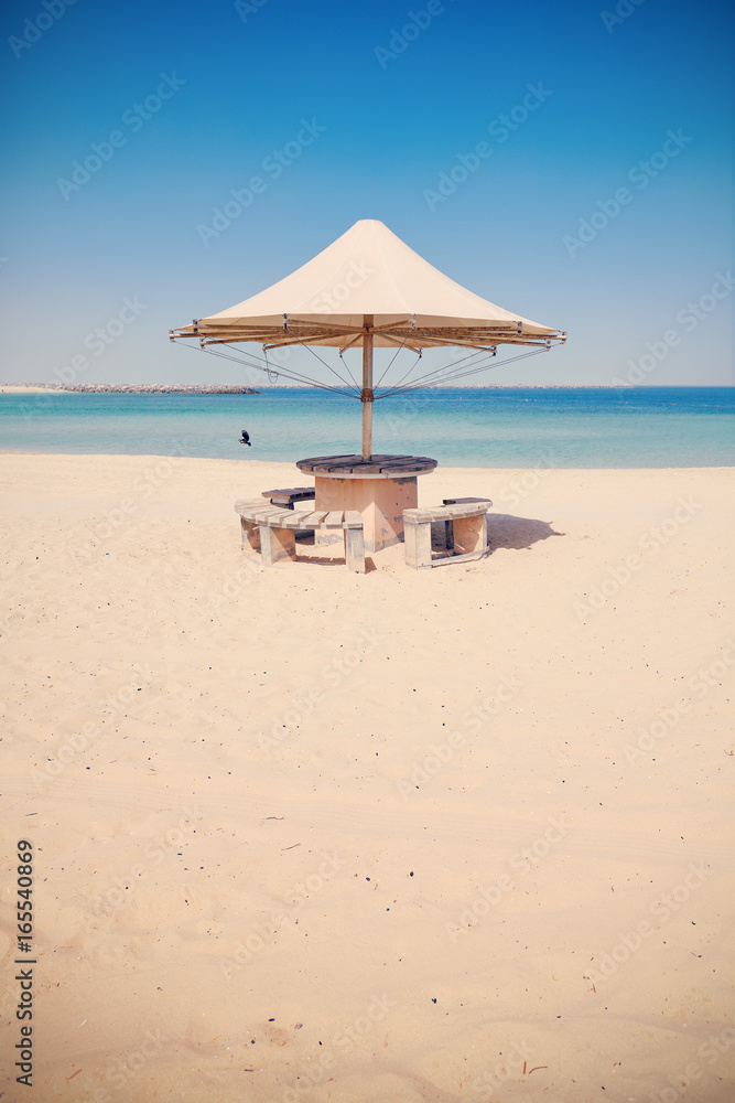Fototapeta premium Retro toned picture of an umbrella on an empty tropical beach.