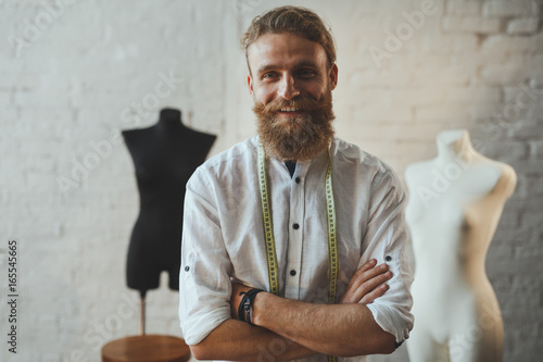 Cheerful dressmaker posing in parlour