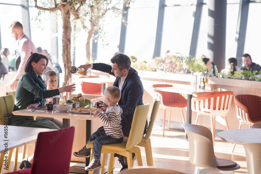Young parents enjoying lunch time with their children Young parents enjoying lunch time with their children