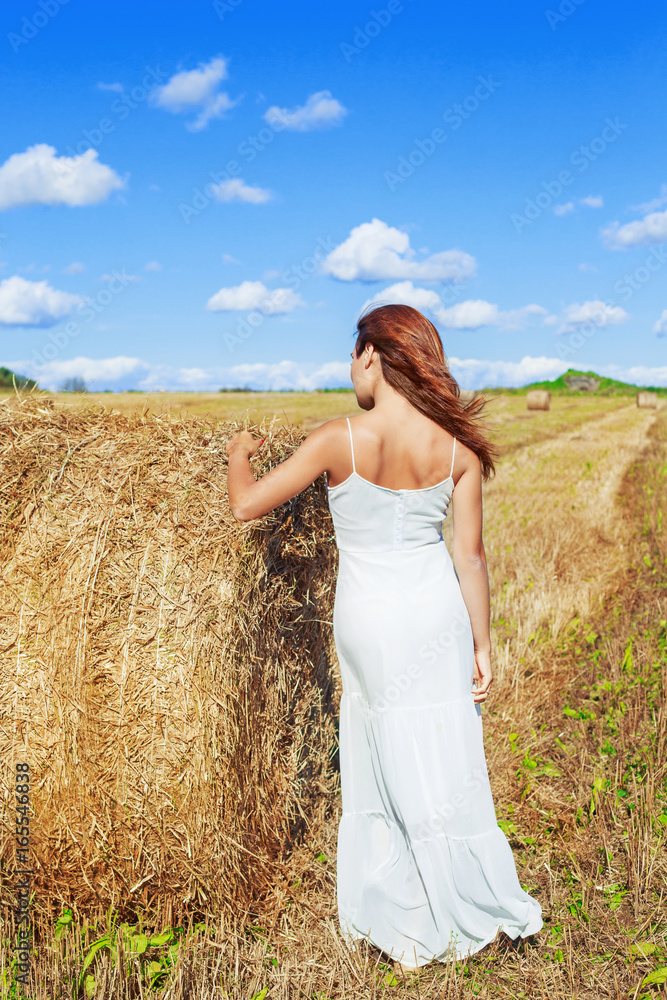 beautiful woman in the harvested  wheat field