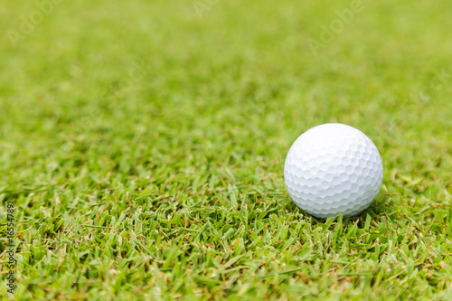 Golf ball on green grass on golf course