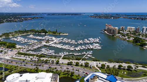 Drone view looking out from downtown Sarasota towards Big Sarasota Pass with Marina Jack, Bayfront Park and Golden Gate in the foreground.