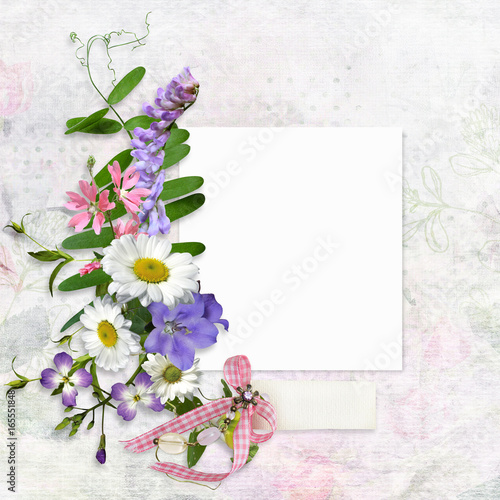 Vintage background with card for photo or text and a bouquet of summer meadow flowers