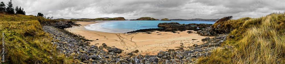 Panorama of a beach and the ocean at the Ards Forest National Park in Donegal Ireland with a dark sky and beautiful nature Panorama of a beach and the ocean at the Ards Forest National Park in Donegal Ireland with a dark sky and beautiful nature