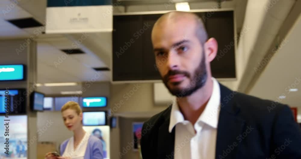 Businessman taking his luggage off the baggage carousel Businessman taking his luggage off the baggage carousel