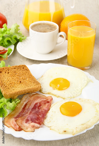 Healthy fatty breakfast with cup of coffee with bacon,eggs