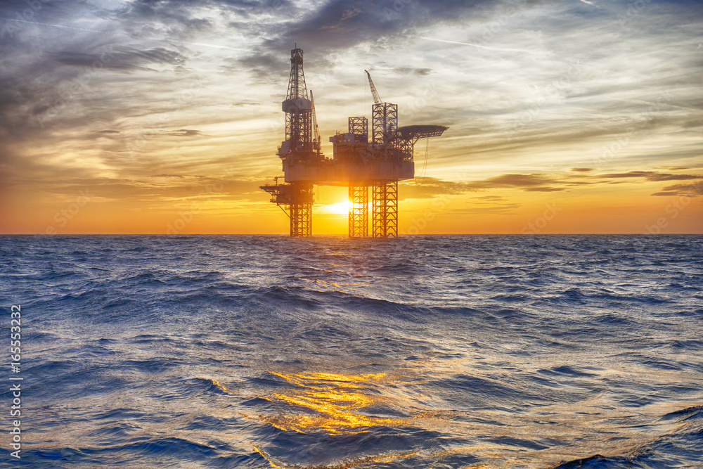 HDR of Offshore Jack Up Rig in The Middle of The Sea at Sunset Time HDR of Offshore Jack Up Rig in The Middle of The Sea at Sunset Time