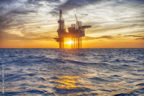 HDR of Offshore Jack Up Rig in The Middle of The Sea at Sunset Time  photo