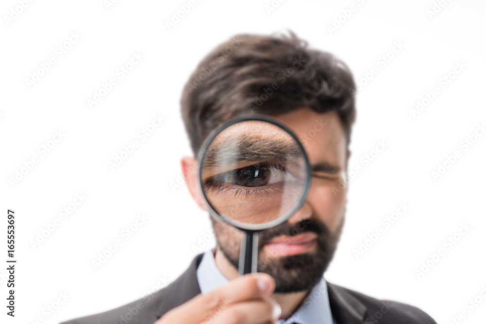 portrait of businessman looking at camera through magnifying glass isolated on white portrait of businessman looking at camera through magnifying glass isolated on white