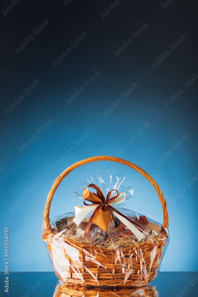 Fototapeta premium gift basket on blue background