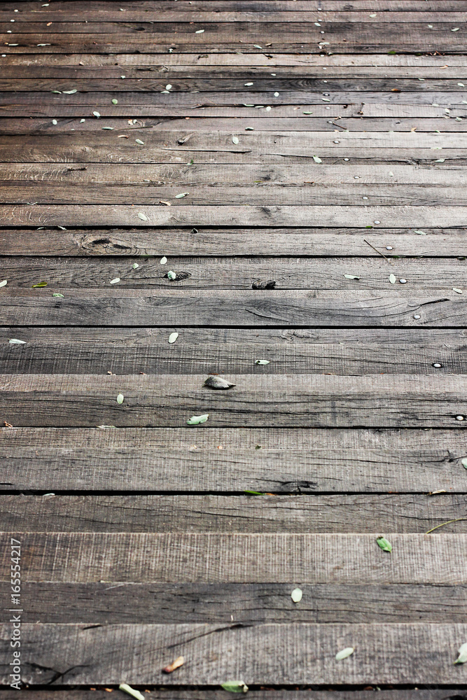 Obraz premium Beautiful background of wooden planks. Wood background close up at high resolution. The wooden floor in the leaves.