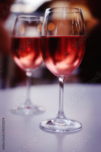 Two glasses of pink wine on a table in the evening