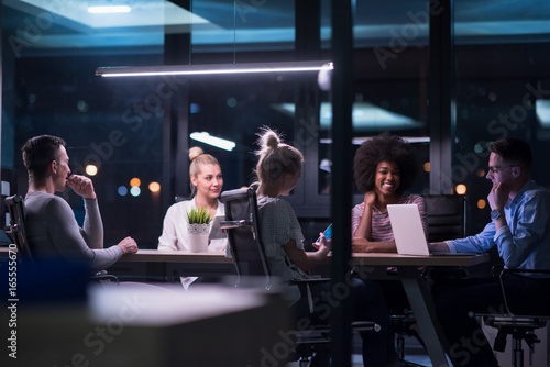 Multiethnic startup business team in night office