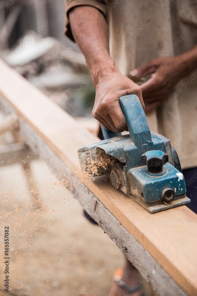 Worker grinds the wood Worker grinds the wood