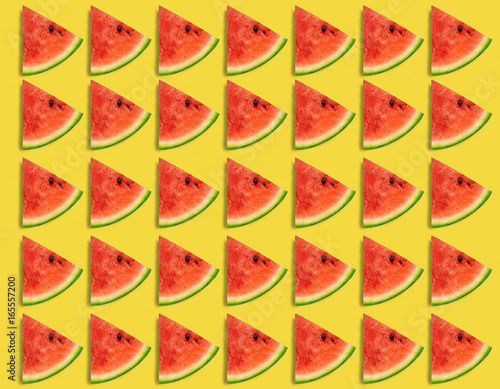 Watermelon pattern. Sliced watermelon on yellow background. Summer concept. Flat lay, top view photo