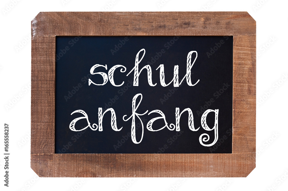 Fototapeta premium Schulanfang (meaning Back to school) written on a vintage blackboard with wooden frame isolated on white background