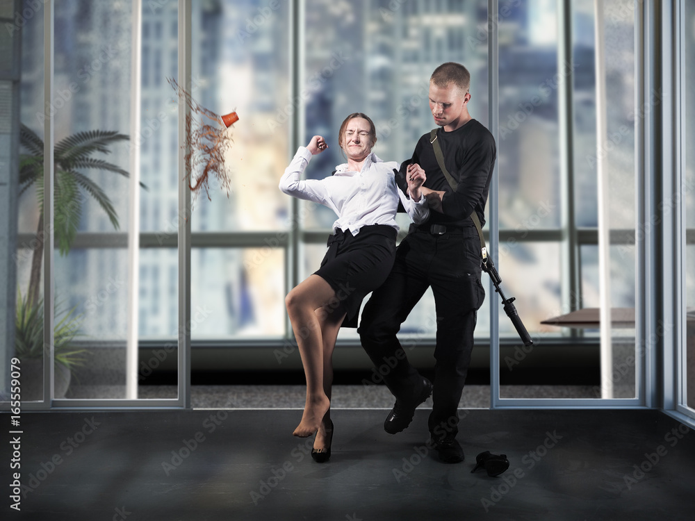 The man with the guns seized the girl, an employee of the office. A