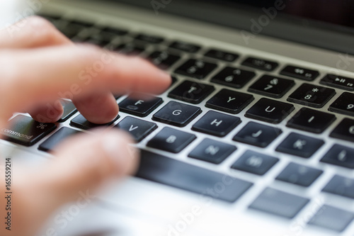 Close up of typing on laptop