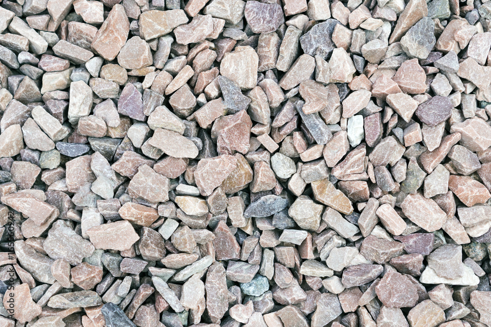 Crushed rock. Small rocks ground. Crushed stone road building material  gravel. Stock Photo by yulikov
