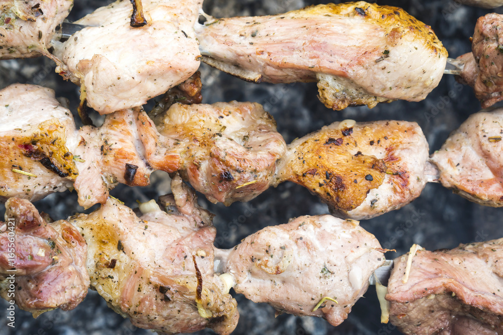 Skewers of pork or meat fried on a barbecue on the grill, barbecue Skewers of pork or meat fried on a barbecue on the grill, barbecue