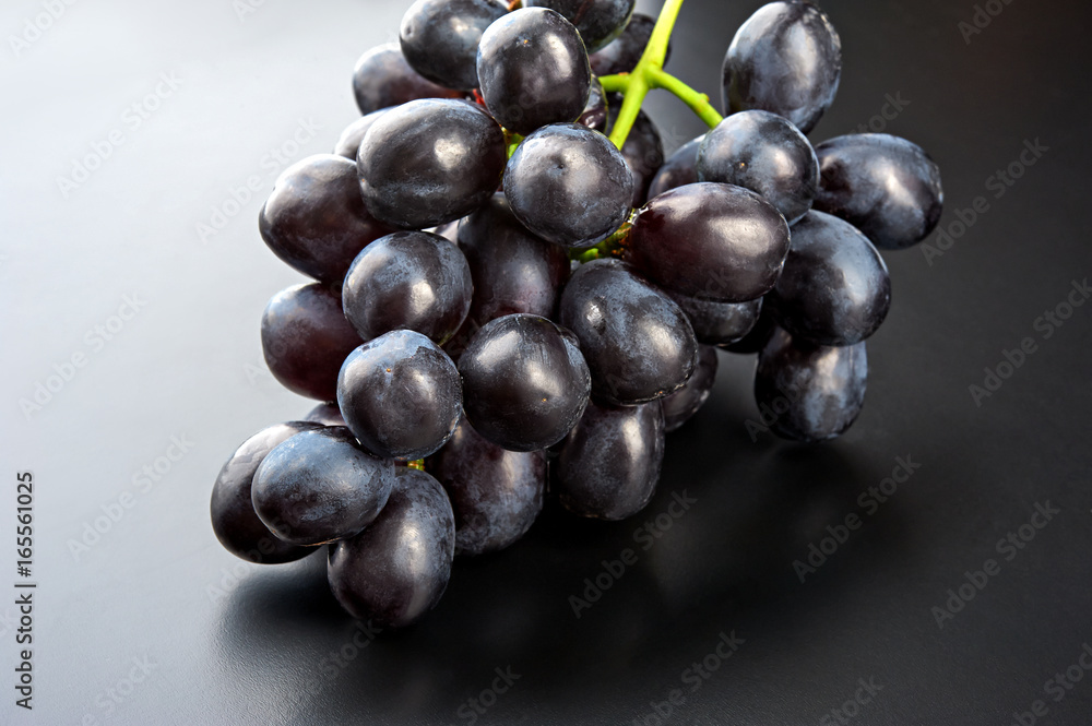 Bunch of black grape isolated on black background Bunch of black grape isolated on black background
