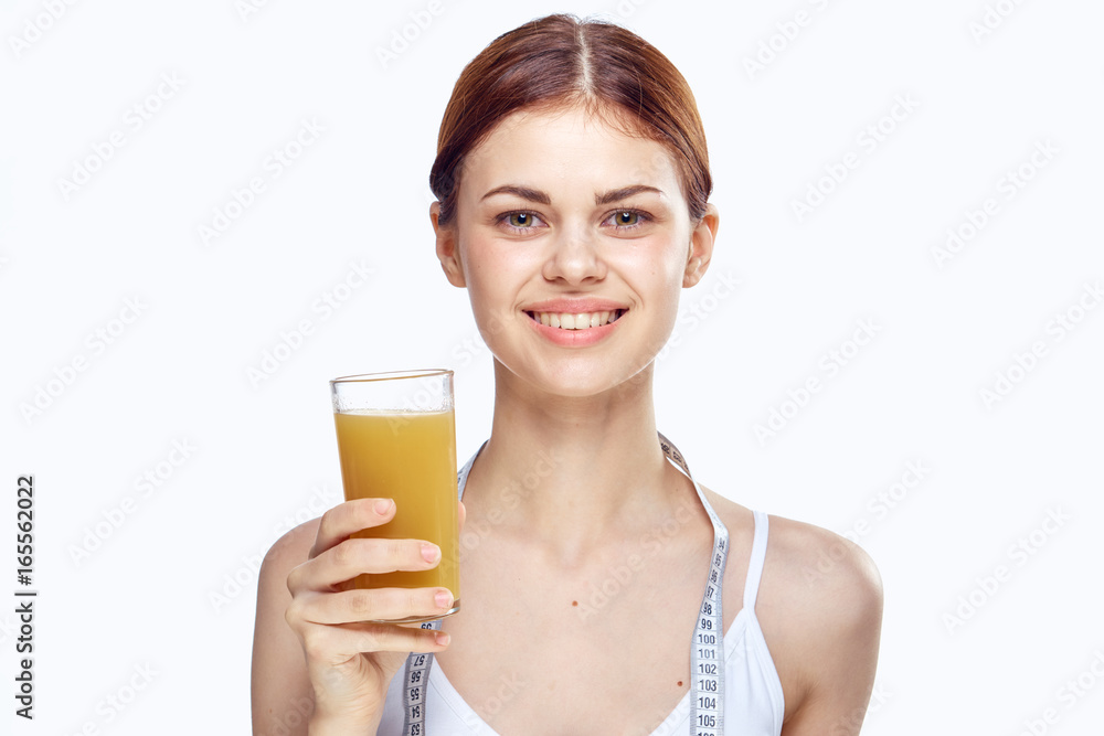 Beautiful young woman on white isolated background holds a glass of fresh juice. Diet, proper nutrition Beautiful young woman on white isolated background holds a glass of fresh juice. Diet, proper nutrition