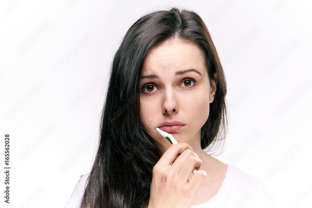 Beautiful young woman on white isolated background brushes teeth Beautiful young woman on white isolated background brushes teeth